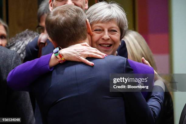 Theresa May, U.K. Prime minister, right, embraces Donald Tusk, president of the European Union , ahead of roundtable discussions at a summit of...