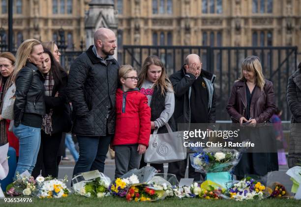 Family react after leaving floral tributes in Parliament Square on the first anniversary of the Westminster Bridge terror attack on March 22, 2018 in...