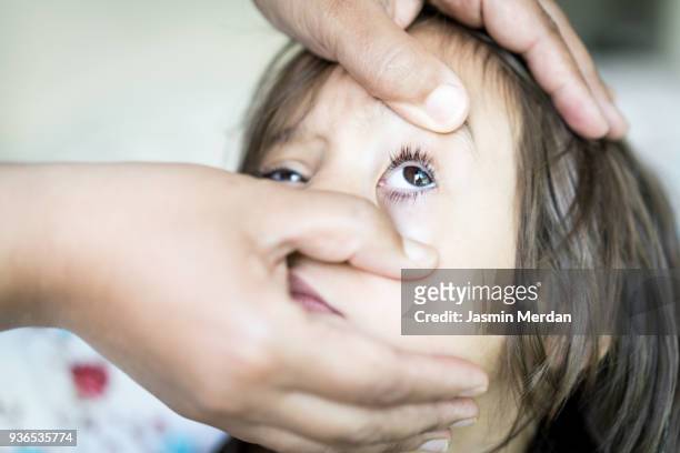 little kid getting checked on his eye - angry eyes stock pictures, royalty-free photos & images