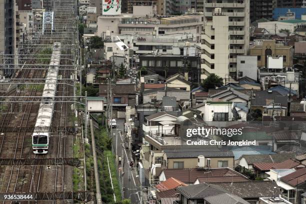 train passing through residential area - kanto region stock pictures, royalty-free photos & images