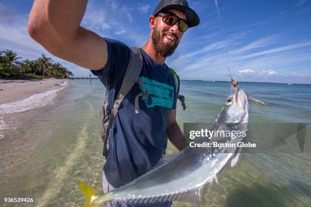 Boston Red Sox pitcher Rick Porcello holds up a skipjack he caught while fly-fishing in San Carlos Bay on Sanibel Island, FL on Feb. 26, 2018. For...