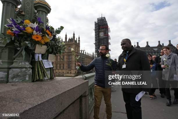 Hospital staff leave flowers on Westminster Bridge in central London on March 22 a year to the day after the Westminster terror attack. - Britain on...