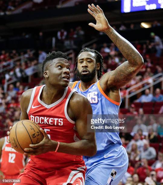 Clint Capela of the Houston Rockets eyes the basket as DeAndre Jordan of the LA Clippers defends at Toyota Center on March 15, 2018 in Houston,...