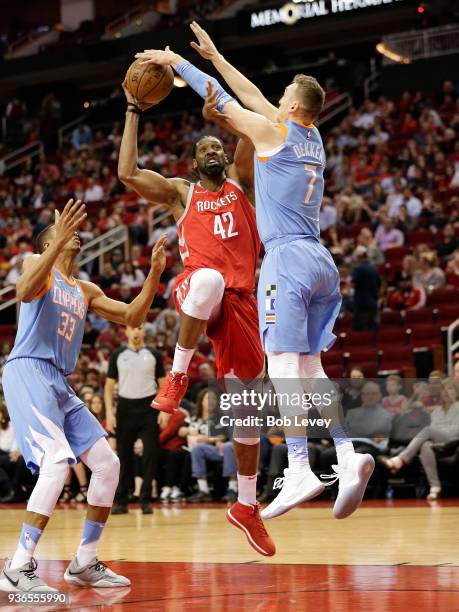 Nene of the Houston Rockets drives between Wesley Johnson of the LA Clippers and Sam Dekker at Toyota Center on March 15, 2018 in Houston, Texas....