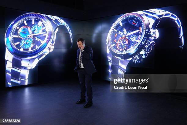 Man chats on the phone as he stands in front of the Casio stand at the BaselWorld watch fair on March 22, 2018 in Basel, Switzerland. The annual...