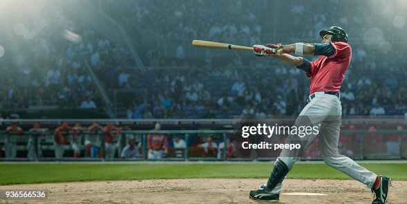 Professional Baseball Player Hits Ball In Mid Swing During Game Professional Baseball Player Hits Ball In Mid Swing During Game
