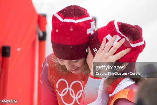 Gold medal winner Michelle Gisin from Switzerland is congratulated by bronze medalist Wendy Holdener , from Switzerland as the result is confirmed...