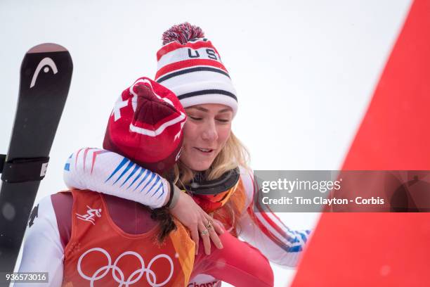 Silver medalist Mikaela Shiffrin of the United States and bronze medalist Wendy Holdener from Switzerland hug as the result is confirmed during the...