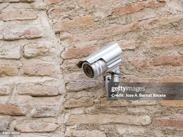 security camera on an ancient wall of bricks. - infrared camera stock pictures, royalty-free photos & images