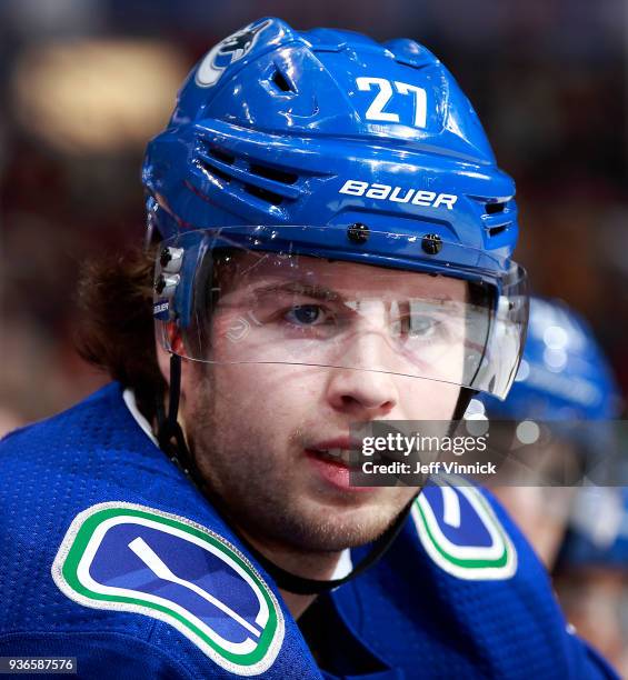 Ben Hutton of the Vancouver Canucks looks on from the bench during their NHL game against the Arizona Coyotes at Rogers Arena March 7, 2018 in...