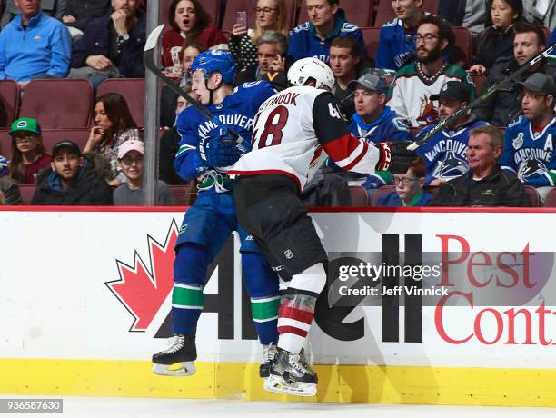 Jordan Martinook of the Arizona Coyotes checks Troy Stecher of the Vancouver Canucks during their NHL game at Rogers Arena March 7, 2018 in...