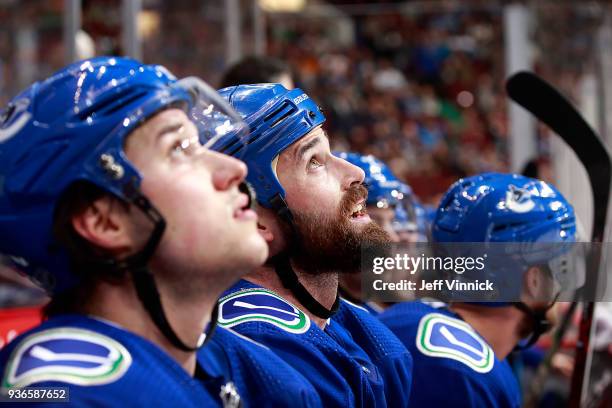 Erik Gudbranson of the Vancouver Canucks looks on from the bench during their NHL game against the Arizona Coyotes at Rogers Arena March 7, 2018 in...