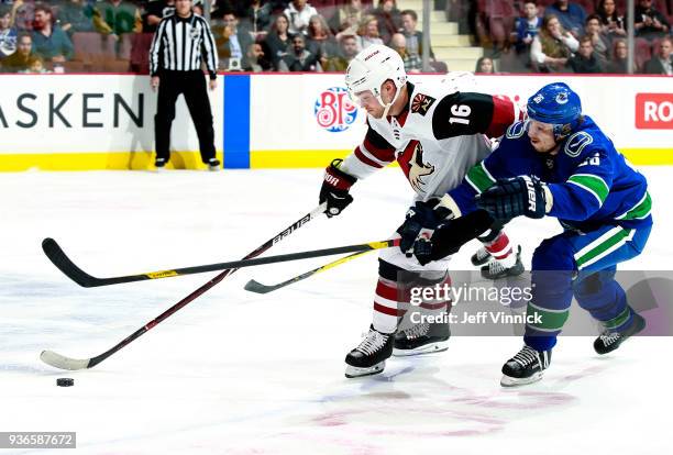 Jussi Jokinen of the Vancouver Canucks checks Max Domi of the Arizona Coyotes during their NHL game at Rogers Arena March 7, 2018 in Vancouver,...