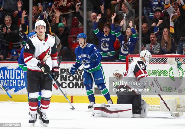 Richard Panik and Darcy Kuemper of the Arizona Coyotes look on dejected as Brendan Leipsic of the Vancouver Canucks celebrates a goal during their...