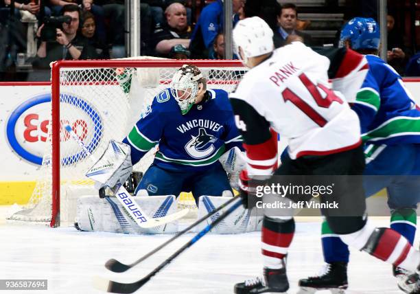 Richard Panik of the Arizona Coyotes looks on as Jacob Markstrom of the Vancouver Canucks makes a save during their NHL game at Rogers Arena March 7,...