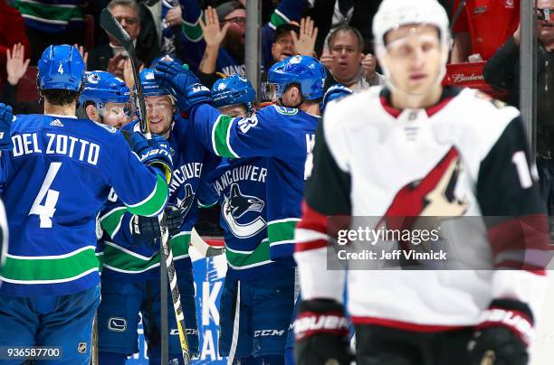 Richard Panik of the Arizona Coyotes looks on dejected as the Vancouver Canucks celebrate the goal of Jussi Jokinen during their NHL game at Rogers...