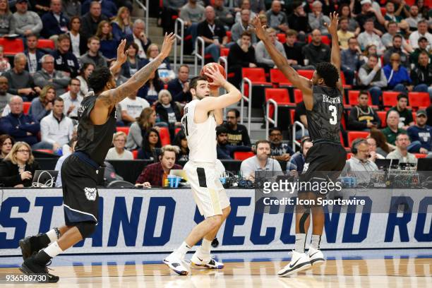 Purdue Boilermakers guard Dakota Mathias looks to pass the ball while being defended by Butler Bulldogs guard Kamar Baldwin and Butler Bulldogs...