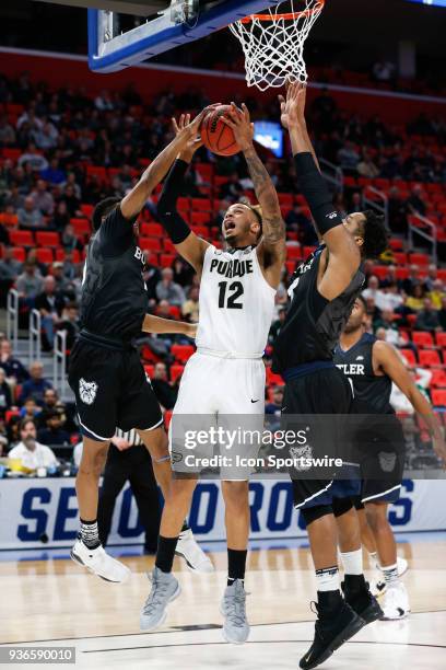 Purdue Boilermakers forward Vincent Edwards shoots over Butler Bulldogs guard Henry Baddley and Butler Bulldogs forward Tyler Wideman during the NCAA...