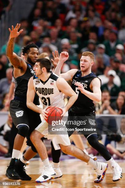 Purdue Boilermakers guard Dakota Mathias looks to pass the ball while being defended by Butler Bulldogs guard Paul Jorgensen and Butler Bulldogs...