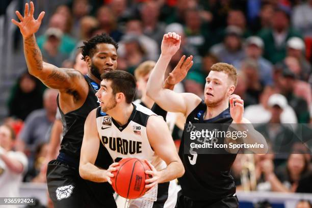 Purdue Boilermakers guard Dakota Mathias looks to pass the ball while being defended by Butler Bulldogs guard Paul Jorgensen and Butler Bulldogs...