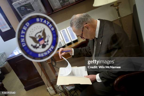 Senate Minority Leader Chuck Schumer goes over his notes before at a news conference at the U.S. Capitol on March 22, 2018 in Washington, DC. House...