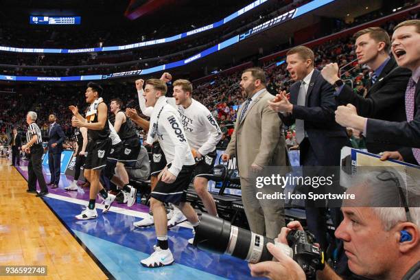 Players on the Butler bench celebrate an offensive play during the NCAA Division I Men's Championship Second Round basketball game between the Butler...