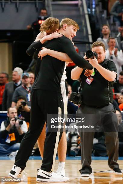 Purdue Boilermakers forward Matt Haarms hugs injured Purdue Boilermakers center Isaac Haas at the conclusion of the NCAA Division I Men's...