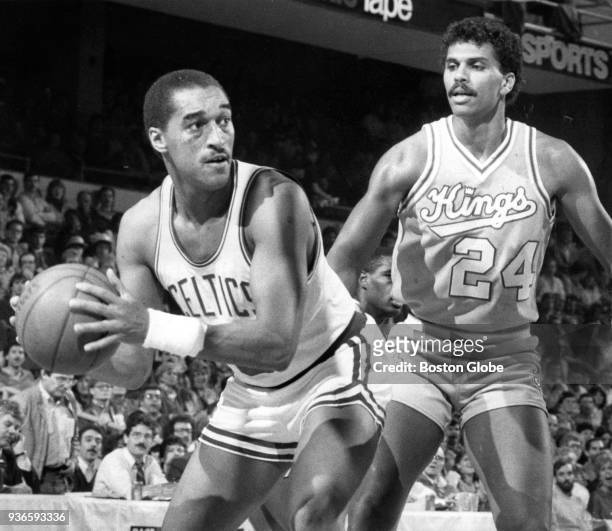 Boston Celtics Dennis Johnson, left, looks for an open player during a game against the Sacramento Kings at the Boston Garden, Dec. 11, 1985.