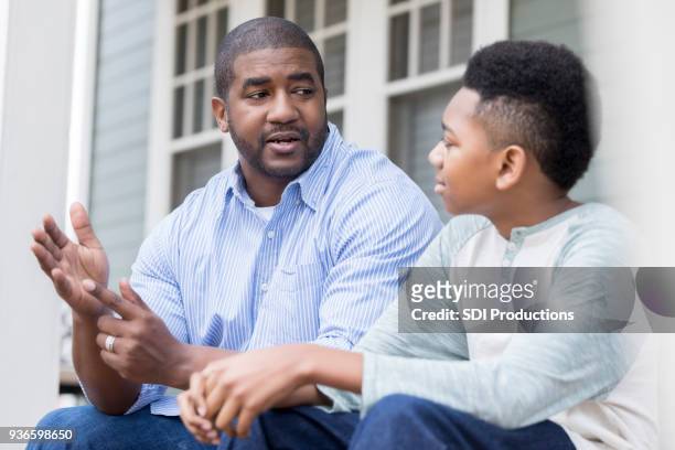 attentive son listening to his dad's advice - role model stock pictures, royalty-free photos & images