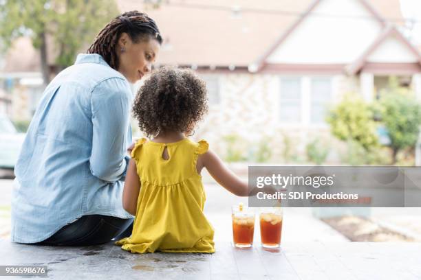 mother and young daughter on front porch - iced tea stock pictures, royalty-free photos & images
