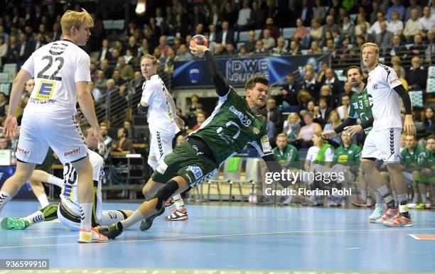 Marian Michalczik of GWD Minden, Erik Schmidt of Fuechse Berlin and Christoffer Rambo of GWD Minden during the DKB Handball Bundesliga game between...