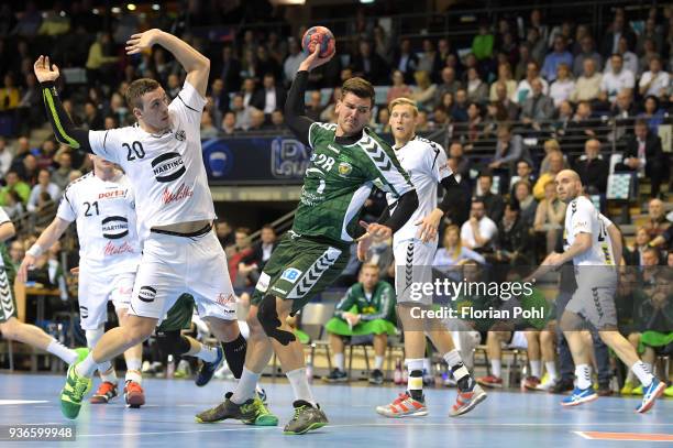 Miljan Pusica of GWD Minden, Erik Schmidt of Fuechse Berlin and Christoffer Rambo of GWD Minden during the DKB Handball Bundesliga game between...