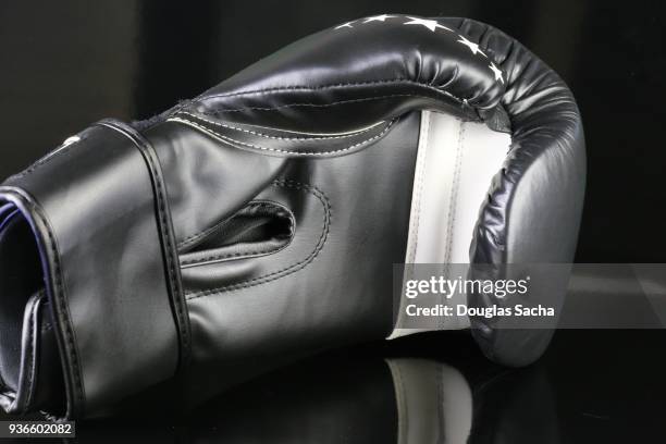 fighters padded glove on a black background - mma glove stock pictures, royalty-free photos & images