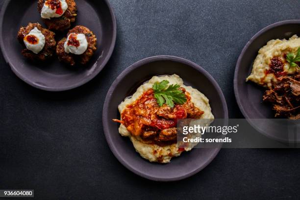 aubergine puree topped with lamb stew. - lamb stew stock pictures, royalty-free photos & images