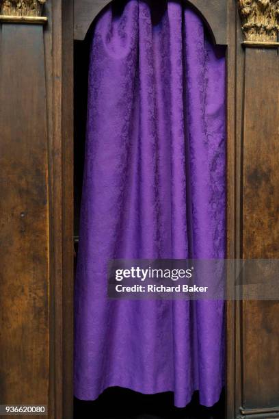 Purple Catholic confessional curtains in St Vitas' Cathedral in Prague Castle, on 18th March in Prague, the Czech Republic. The Metropolitan...