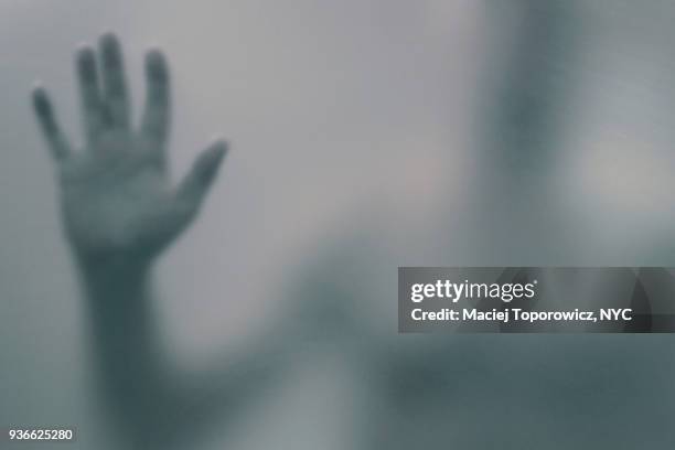 silhouette of a person behind a translucent glass. - schocktaktik stock-fotos und bilder