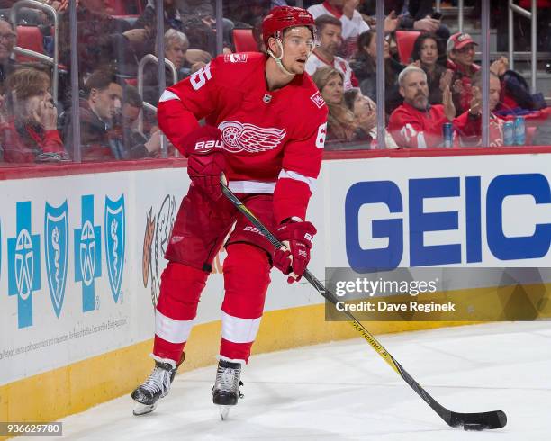 Danny DeKeyser of the Detroit Red Wings skates around the net with the puck against the Philadelphia Flyers during an NHL game at Little Caesars...