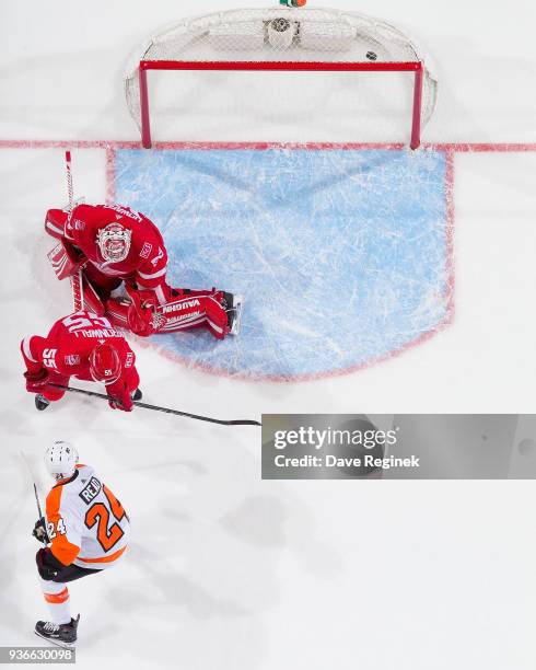 Shayne Gostisbehere of the Philadelphia Flyers s scores a third period goal on Jimmy Howard of the Detroit Red Wings as Niklas Kronwall of the Wings...