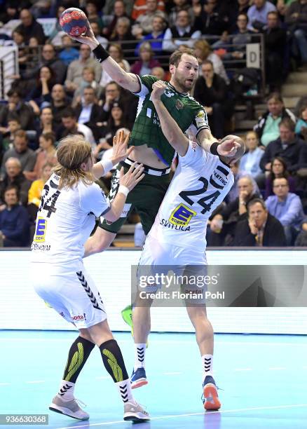 Andreas Cederholm of GWD Minden, Steffen Faeth of Fuechse Berlin and Aleksandar Svitlica of GWD Minden during the DKB Handball Bundesliga game...