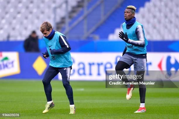 Antoine Griezmann and Paul Pogba warm up during a France football team training session before the friendly match against Colombia on March 22, 2018...