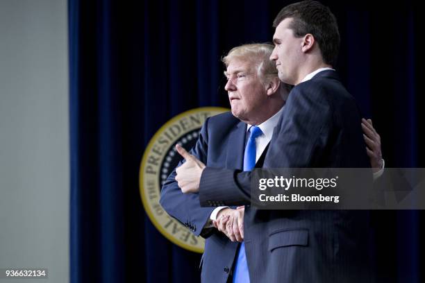 President Donald Trump, left, shakes hands with moderator Charlie Kirk after a discussion at the Generation Next forum in the Eisenhower Executive...