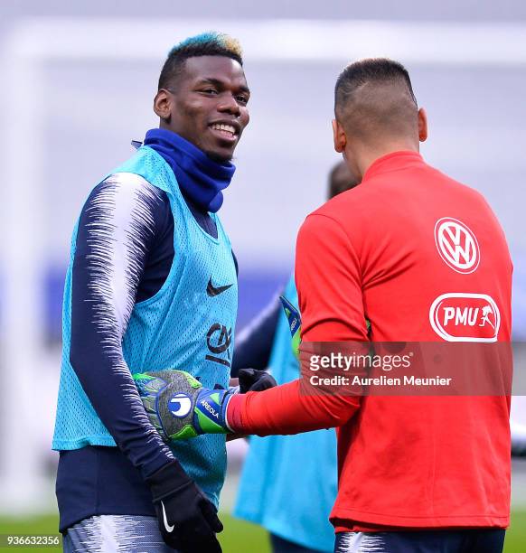 Paul Pogba and Alphonse Areola react during a France football team training session before the friendly match against Colombia on March 22, 2018 in...