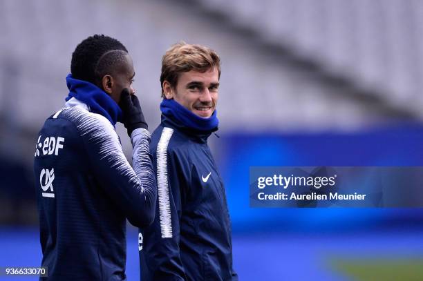 Blaise Matuidi and Antoine Griezmann react as they arrive to a France football team training session before the friendly match against Colombia on...