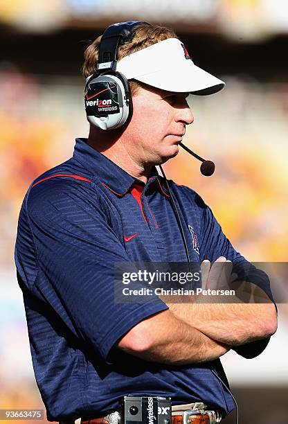 Head coach Mike Stoops of the Arizona Wildcats walks the sidelines during the college football game against the Arizona State Sun Devils at Sun Devil...