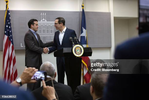 Ricardo Rossello, governor of Puerto Rico, shakes hands with Steve Mnuchin, U.S. Treasury secretary, right, during a press conference in San Juan,...