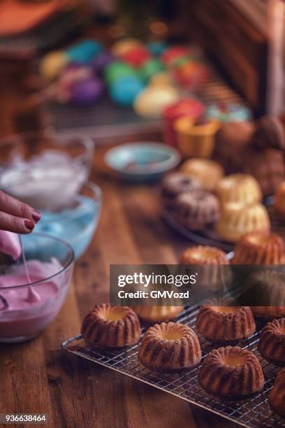 preparing small easter bunt cakes - bunt cake stock pictures, royalty-free photos & images