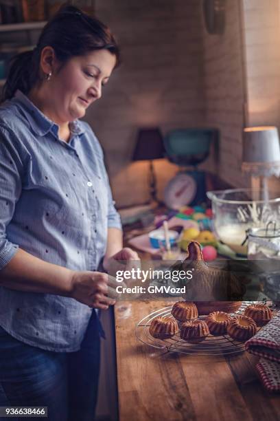 preparing small easter bunt cakes - bunt cake stock pictures, royalty-free photos & images