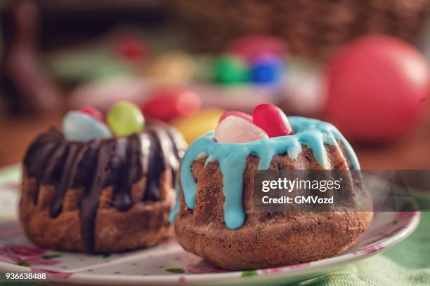 small easter bunt cakes with icing and sweets - bunt cake stock pictures, royalty-free photos & images