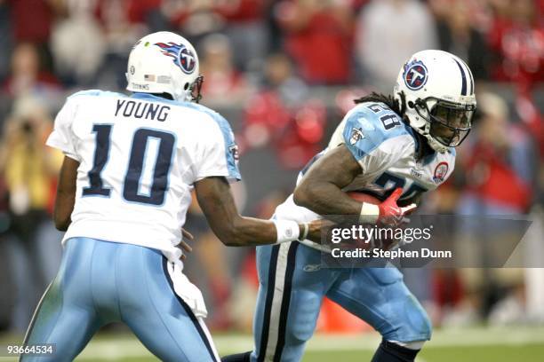 Running Back Chris Johnson of the Tennessee Titans takes a handoff from quarterback Vince Young against the Houston Texans on November 23, 2009 at...