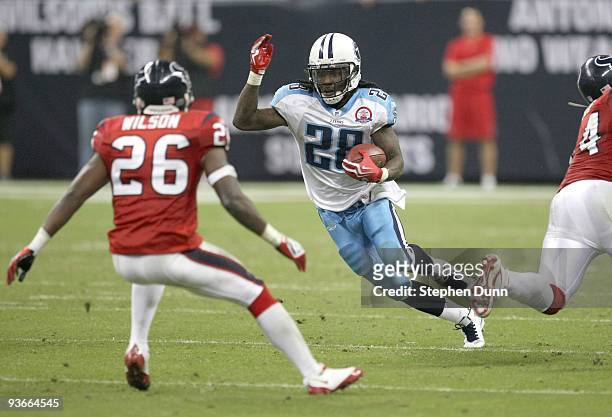 Running Back Chris Johnson of the Tennessee Titans carries the ball against safety Eugene Wilson of the Houston Texans on November 23, 2009 at...